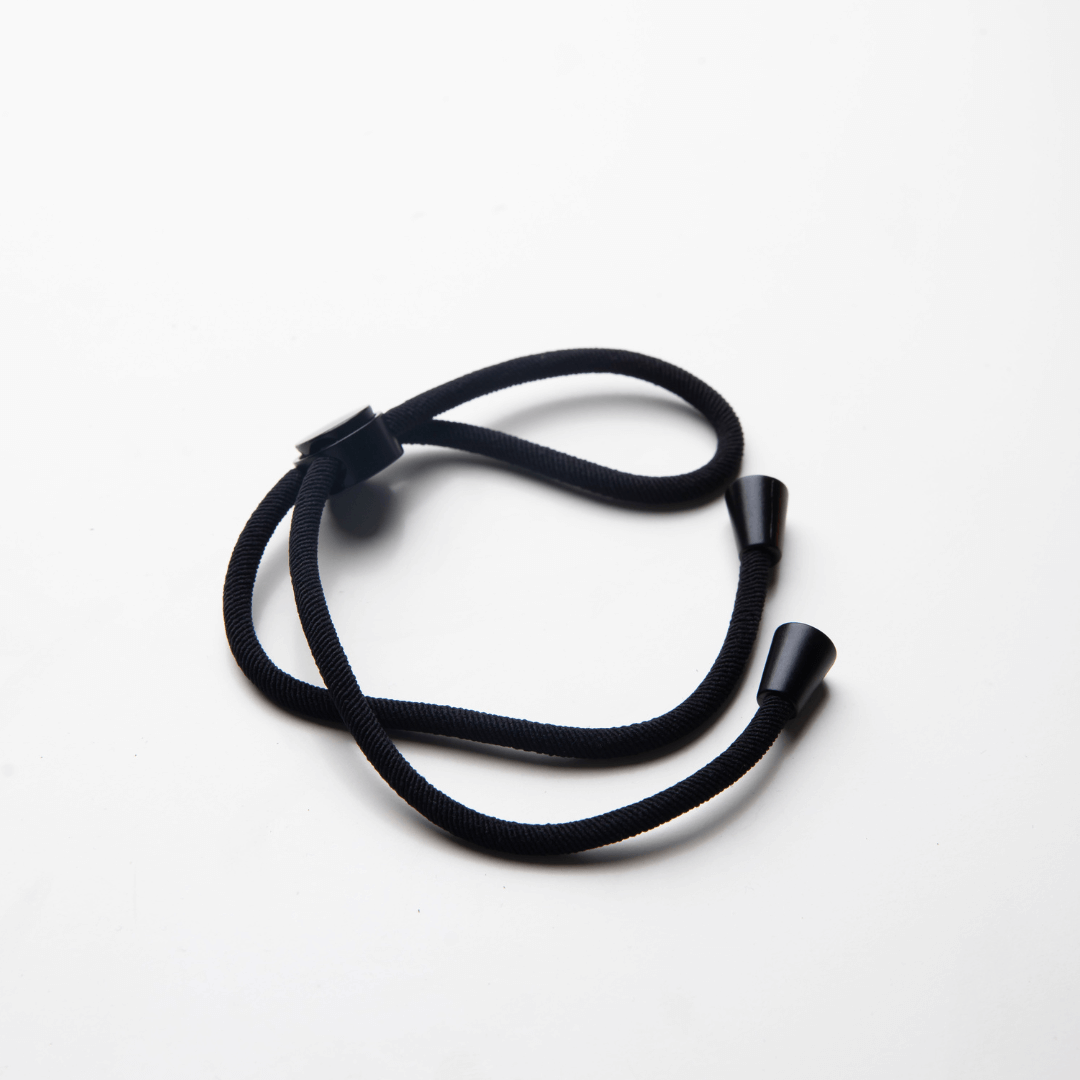 Adjustable black hair tie designed for textured, curly, and afro hair types to prevent breakage and adjust tension.