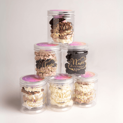 Set of six satin scrunchies in clear jars, perfect for maintaining curls without heat and styling with ease.